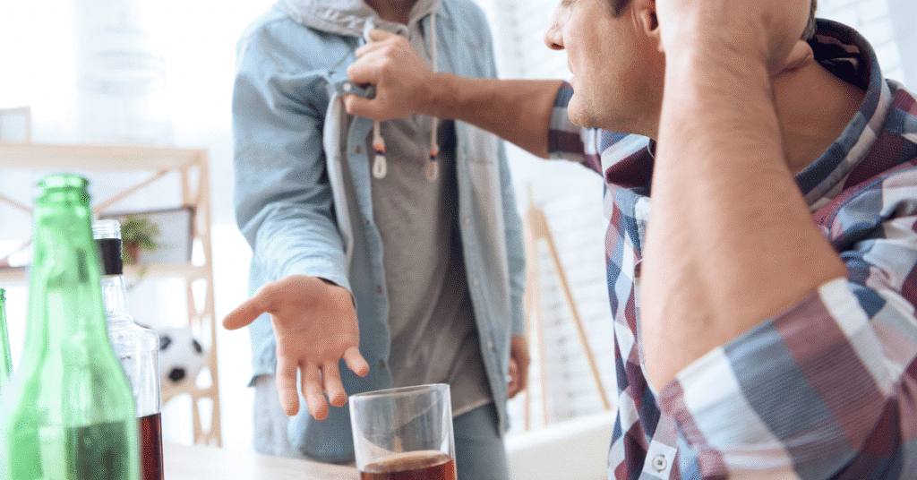 Man confronting a friend about excessive drinking