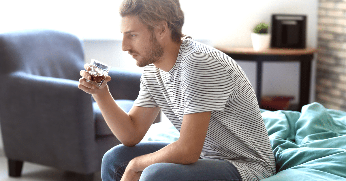Man drinking alcohol at home