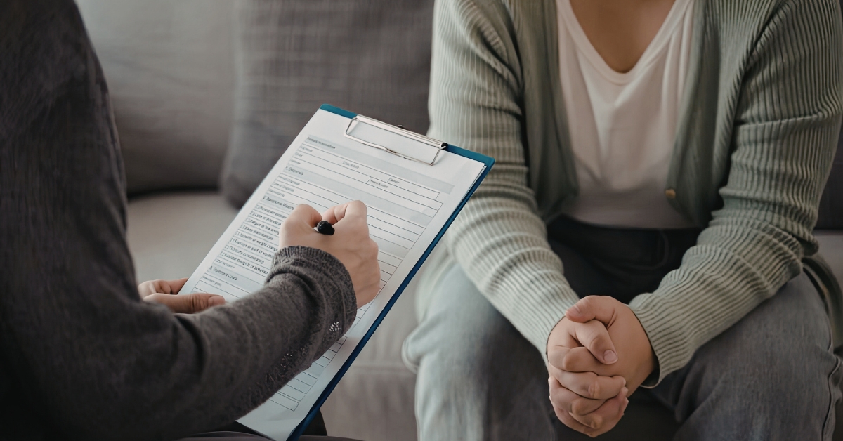 Therapist taking notes during counseling session