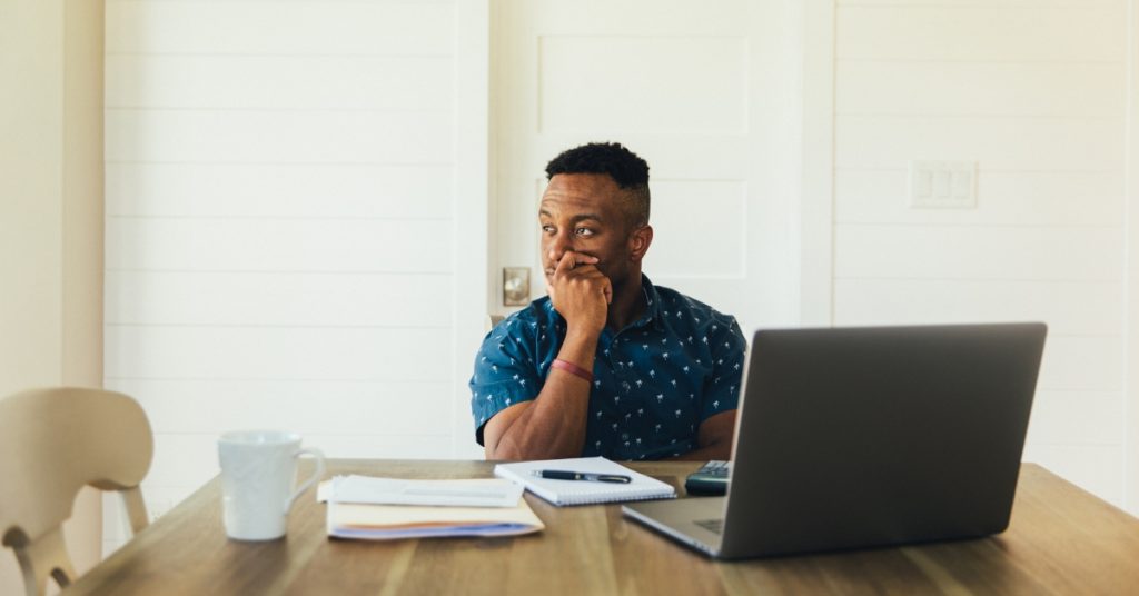 Thoughtful man with laptop